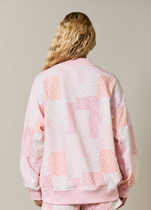 Person wearing a pink and white checkered outfit on a beige background