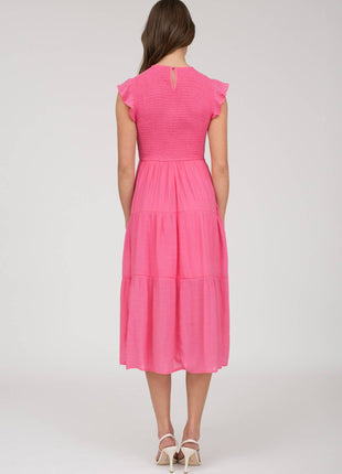 Woman wearing a pink dress on a white background