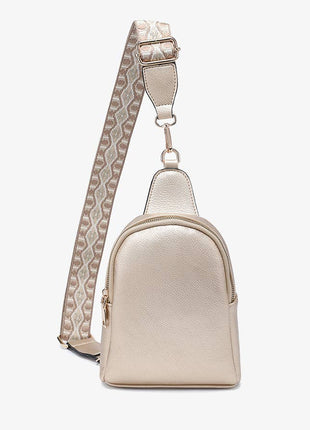 Beige crossbody bag with a patterned strap on a white background
