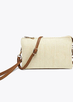 Beige handbag with brown strap on a white background