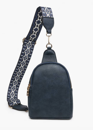 Black leather sling bag with decorative strap on a white background