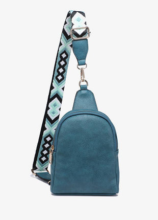 Blue backpack with a patterned strap on a white background