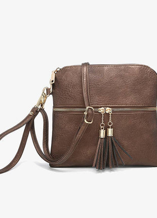 Brown leather crossbody bag with gold accents on a white background