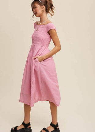 Woman wearing a pink dress on a beige background