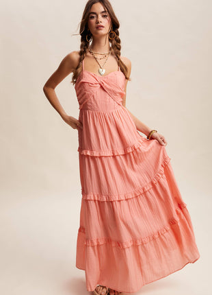Woman wearing a coral pink dress with a plain background