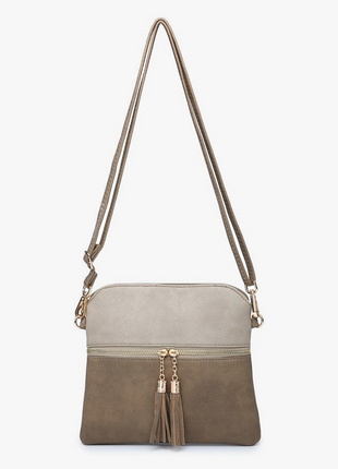 Crossbody bag with a beige top half and brown bottom half on a white background