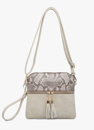 Crossbody bag with snake print pattern on a white background