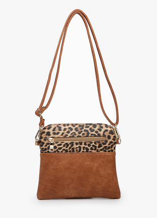 Brown crossbody bag with leopard print top section on a white background