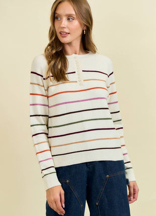 Woman wearing a striped sweater with a beige background