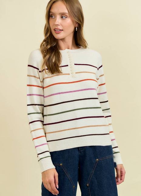 Woman wearing a striped sweater with a beige background