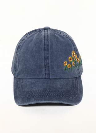 Blue baseball cap with sunflower embroidery on a white background