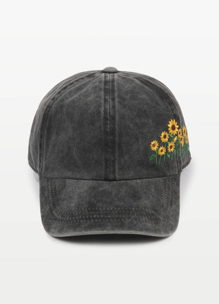 Black cap with sunflower embroidery on a white background
