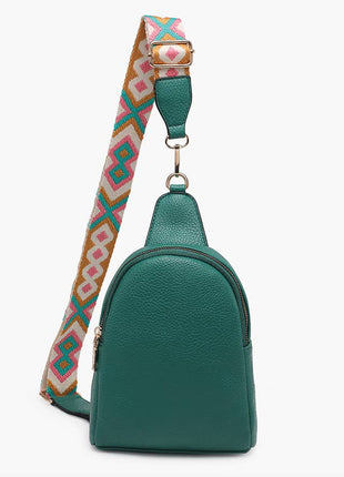 Green leather sling bag with a colorful patterned strap on a white background