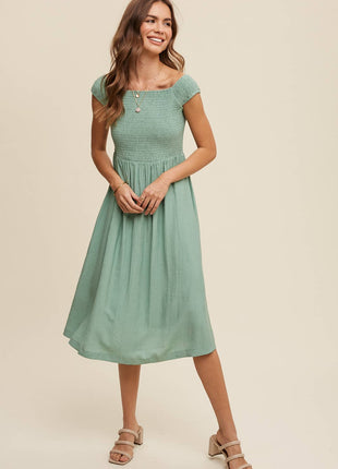 Woman wearing a green dress on a beige background