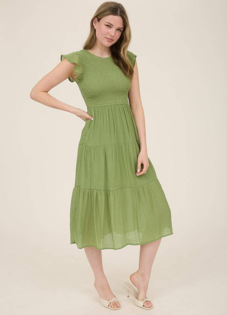 Woman wearing a green dress on a beige background