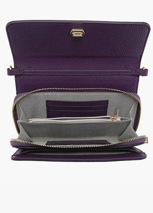 Purple handbag with open flap showing interior on a white background