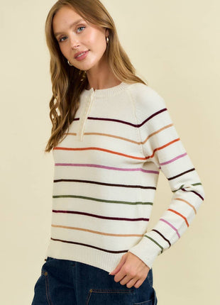 Woman wearing a striped sweater with a beige background