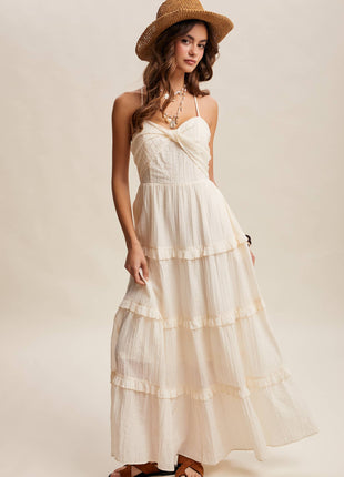 Woman wearing a white dress and straw hat on a plain background