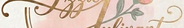 A decorative logo or label reading 'Izzie Julivant' in gold cursive script, framed by a gold oval border with a soft pink watercolor wash and a small pink flower with green leaves on a light textured background.