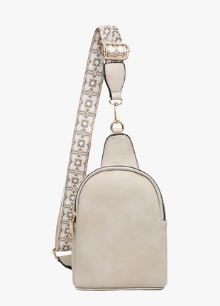 Light cream backpack with a decorative rhinestone strap on a white background