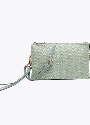 Light green woven handbag with a strap on a white background