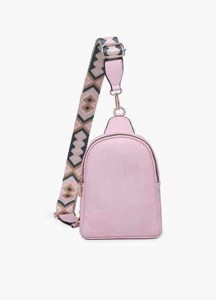 Pink backpack with a patterned strap on a white background