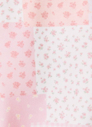 Set of four fabric swatches with floral patterns on a pink and white background