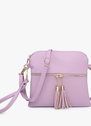Purple handbag with gold accents and tassels on a white background