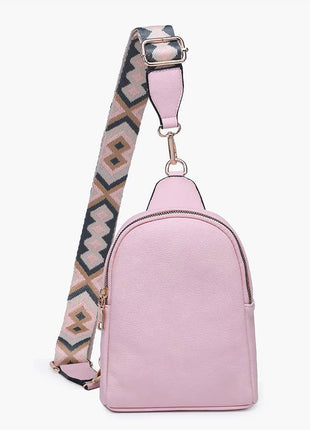 Pink backpack with a patterned strap on a white background