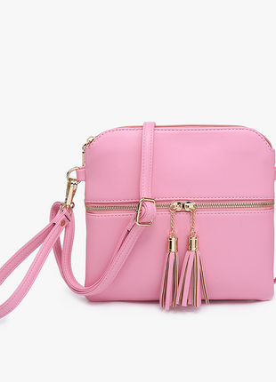 Pink handbag with tassels on a white background