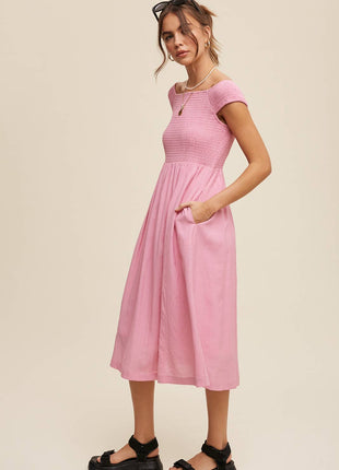 Woman wearing a pink dress on a beige background
