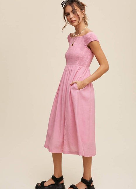Woman wearing a pink dress on a beige background