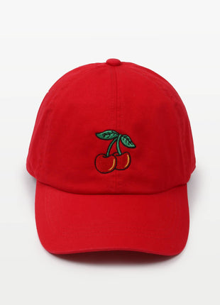 A bright red baseball cap featuring an embroidered cherry motif on the front, set against a clean white background.