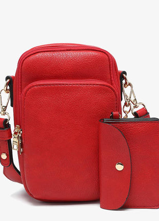 Red leather crossbody bag with matching pouch on a white background