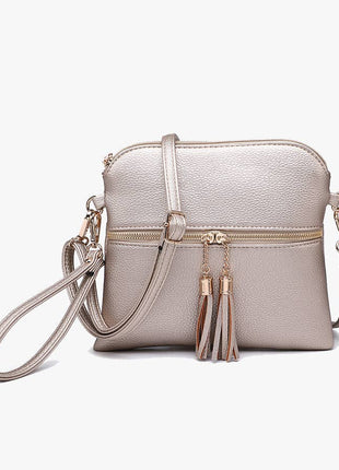 Silver crossbody bag with tassel details on a white background