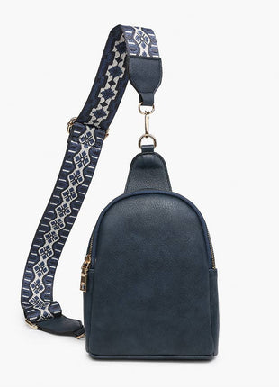 Black leather sling bag with decorative strap on a white background