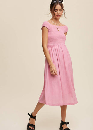 Woman wearing a pink dress on a beige background