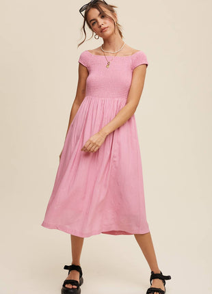 Woman wearing a pink dress against a beige background