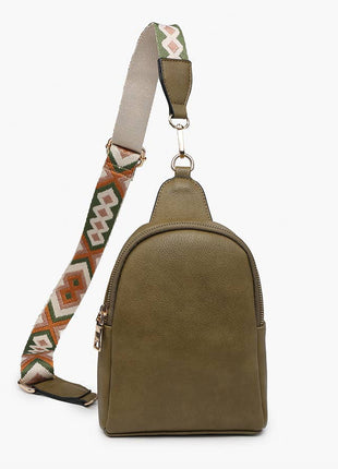 Green suede sling bag with a patterned strap on a white background
