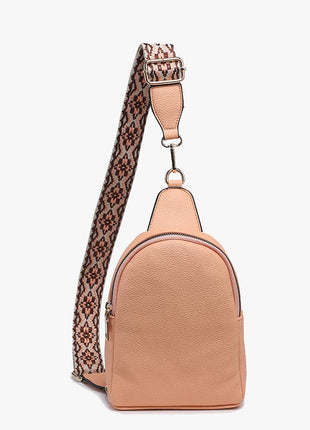 Tan backpack with a patterned strap on a white background