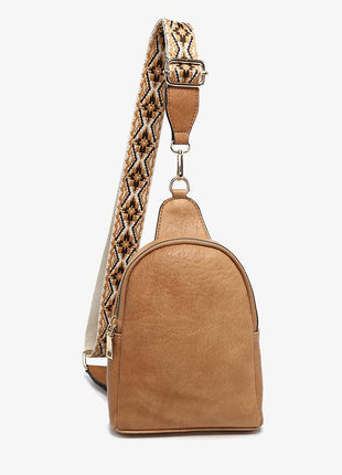 Tan backpack with a patterned strap on a white background