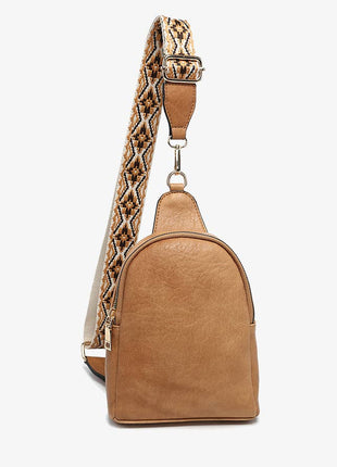 Tan backpack with a patterned strap on a white background