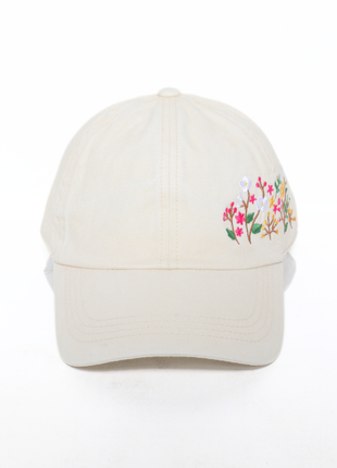 White cap with floral embroidery on a white background