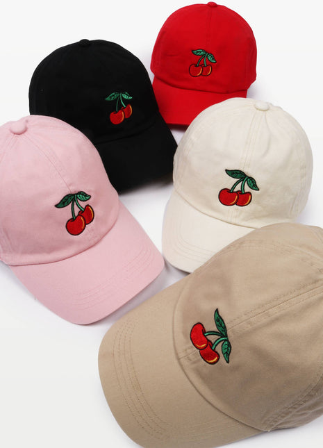 Five baseball caps in black, red, pink, cream, and beige, each featuring an embroidered cherry design on the front, arranged on a white background.