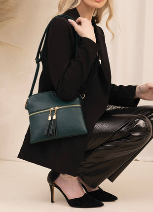 Woman holding a teal handbag in a minimalistic setting
