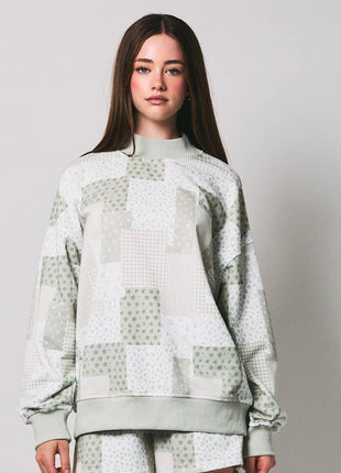 Person wearing a patterned outfit on a plain background