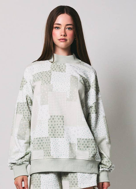 Person wearing a patterned outfit on a plain background
