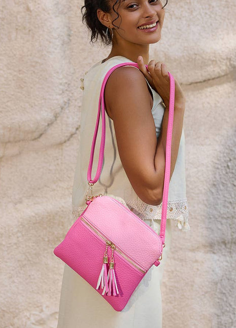 Woman holding a pink handbag against a textured beige wall