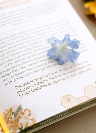 Floral bookmark with blue flower on a book page