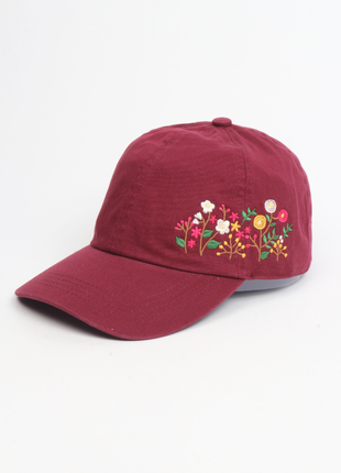 Maroon cap with floral embroidery on a white background